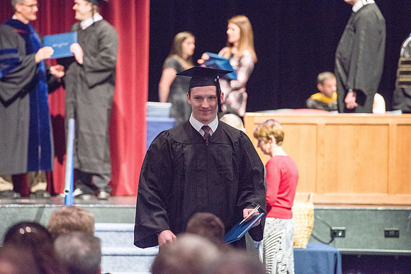 Convocation for College of Physical Sciences and Engineering in the Hart Auditorium.  Graduates receive their diploma covers.
