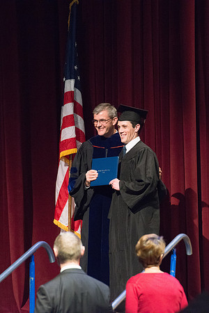 Convocation for College of Physical Sciences and Engineering in the Hart Auditorium.  Graduates receive their diploma covers.