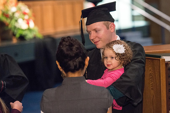 Convocation for College of Physical Sciences and Engineering in the Hart Auditorium.  Graduates receive their diploma covers.