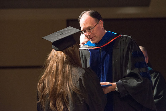 Convocation for College of Language and Letters.  Bishop W. Christopher Waddell and President Henry J Eyring present the graduates with their diploma covers.