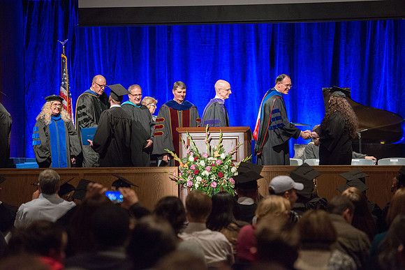 Convocation for College of Language and Letters.  Bishop W. Christopher Waddell and President Henry J Eyring present the graduates with their diploma covers.