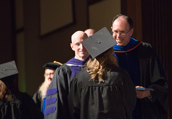 Convocation for College of Language and Letters.  Bishop W. Christopher Waddell and President Henry J Eyring present the graduates with their diploma covers.