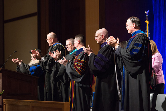Convocation for College of Language and Letters.  Bishop W. Christopher Waddell, President Henry J Eyring and Eric Walz applaud the graduates.