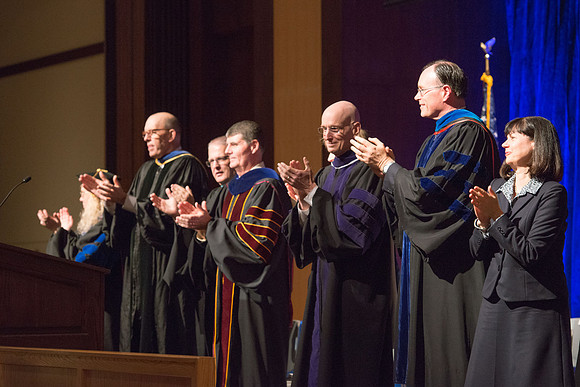Convocation for College of Language and Letters.  Bishop W. Christopher Waddell, President Henry J Eyring and Eric Walz applaud the graduates.