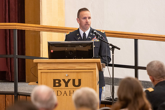 Four graduates from the BYU-Idaho ROTC program gather with the families and have a ceremonial commissioning.