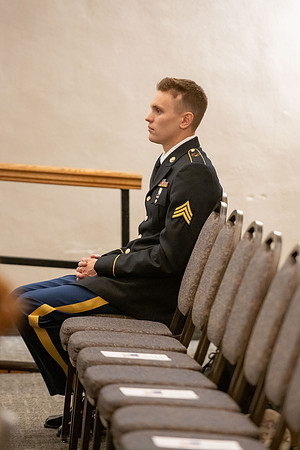 Four graduates from the BYU-Idaho ROTC program gather with the families and have a ceremonial commissioning.