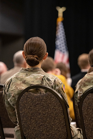 Four graduates from the BYU-Idaho ROTC program gather with the families and have a ceremonial commissioning.