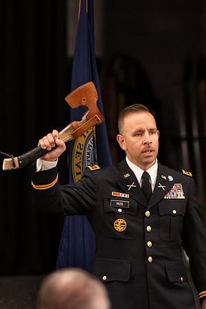 Four graduates from the BYU-Idaho ROTC program gather with the families and have a ceremonial commissioning.