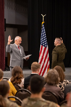 Four graduates from the BYU-Idaho ROTC program gather with the families and have a ceremonial commissioning.