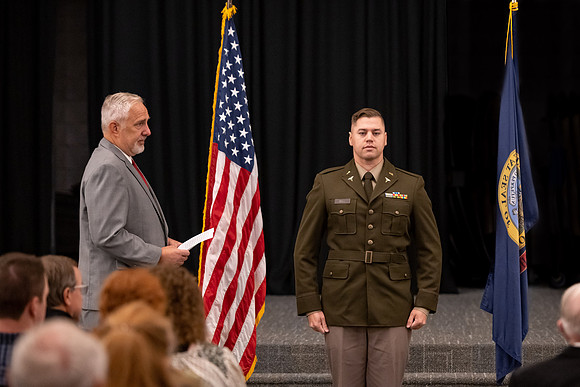 Four graduates from the BYU-Idaho ROTC program gather with the families and have a ceremonial commissioning.