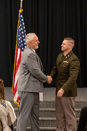 Four graduates from the BYU-Idaho ROTC program gather with the families and have a ceremonial commissioning.