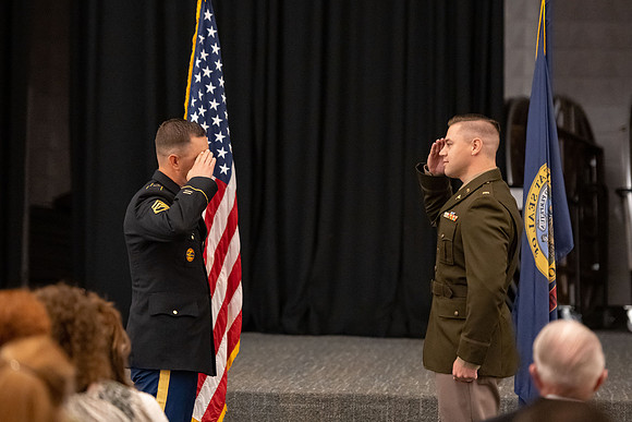 Four graduates from the BYU-Idaho ROTC program gather with the families and have a ceremonial commissioning.