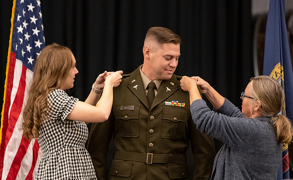 Four graduates from the BYU-Idaho ROTC program gather with the families and have a ceremonial commissioning.