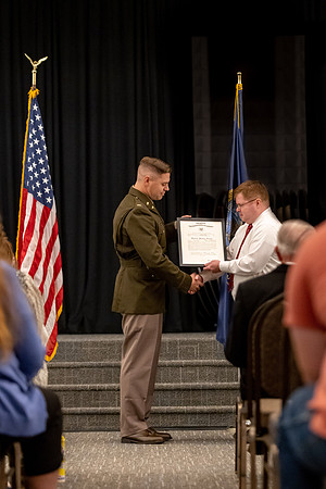 Four graduates from the BYU-Idaho ROTC program gather with the families and have a ceremonial commissioning.