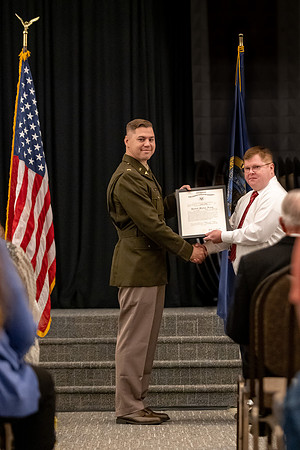 Four graduates from the BYU-Idaho ROTC program gather with the families and have a ceremonial commissioning.