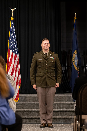 Four graduates from the BYU-Idaho ROTC program gather with the families and have a ceremonial commissioning.