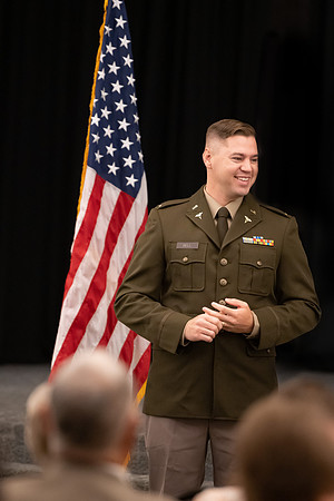 Four graduates from the BYU-Idaho ROTC program gather with the families and have a ceremonial commissioning.