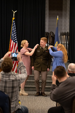 Four graduates from the BYU-Idaho ROTC program gather with the families and have a ceremonial commissioning.