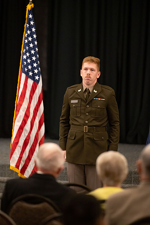 Four graduates from the BYU-Idaho ROTC program gather with the families and have a ceremonial commissioning.