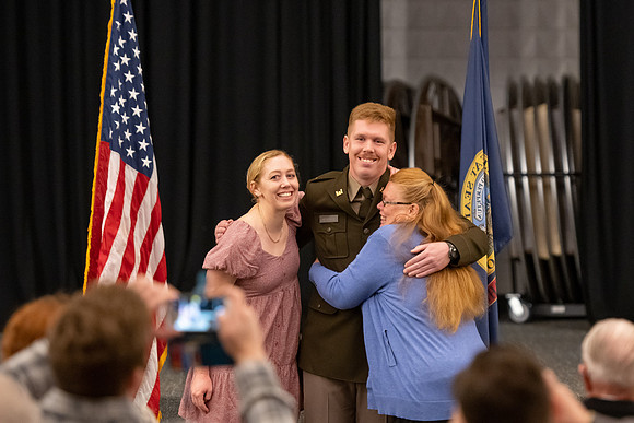 Four graduates from the BYU-Idaho ROTC program gather with the families and have a ceremonial commissioning.