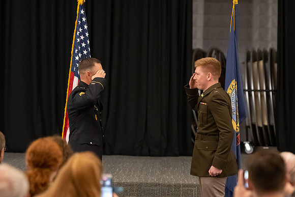 Four graduates from the BYU-Idaho ROTC program gather with the families and have a ceremonial commissioning.