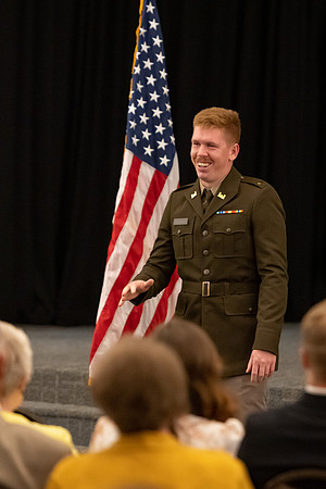 Four graduates from the BYU-Idaho ROTC program gather with the families and have a ceremonial commissioning.