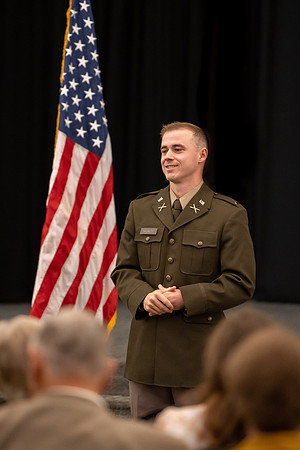 Four graduates from the BYU-Idaho ROTC program gather with the families and have a ceremonial commissioning.