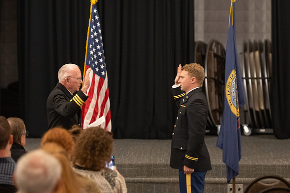 Four graduates from the BYU-Idaho ROTC program gather with the families and have a ceremonial commissioning.