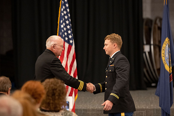 Four graduates from the BYU-Idaho ROTC program gather with the families and have a ceremonial commissioning.