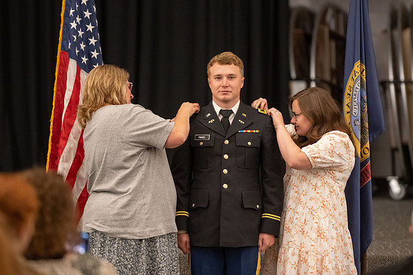 Four graduates from the BYU-Idaho ROTC program gather with the families and have a ceremonial commissioning.