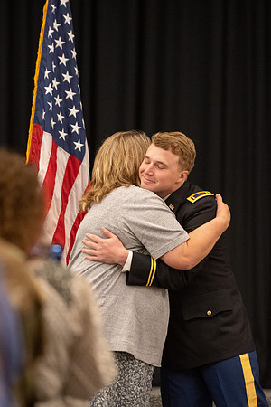 Four graduates from the BYU-Idaho ROTC program gather with the families and have a ceremonial commissioning.
