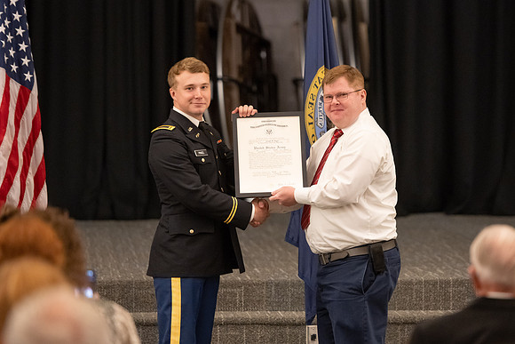 Four graduates from the BYU-Idaho ROTC program gather with the families and have a ceremonial commissioning.