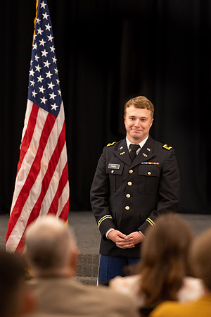 Four graduates from the BYU-Idaho ROTC program gather with the families and have a ceremonial commissioning.