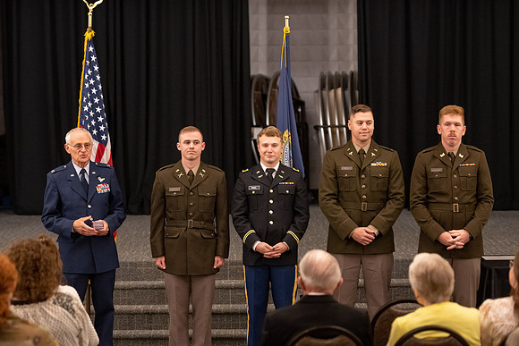 Four graduates from the BYU-Idaho ROTC program gather with the families and have a ceremonial commissioning.
