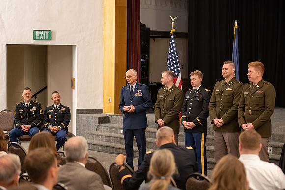 Four graduates from the BYU-Idaho ROTC program gather with the families and have a ceremonial commissioning.