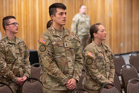 Four graduates from the BYU-Idaho ROTC program gather with the families and have a ceremonial commissioning.