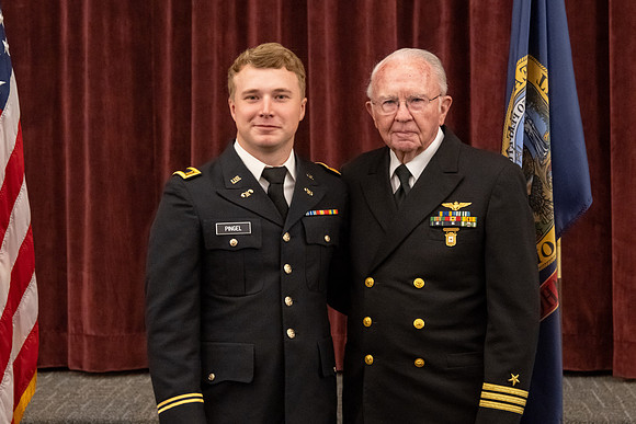 Four graduates from the BYU-Idaho ROTC program gather with the families and have a ceremonial commissioning.