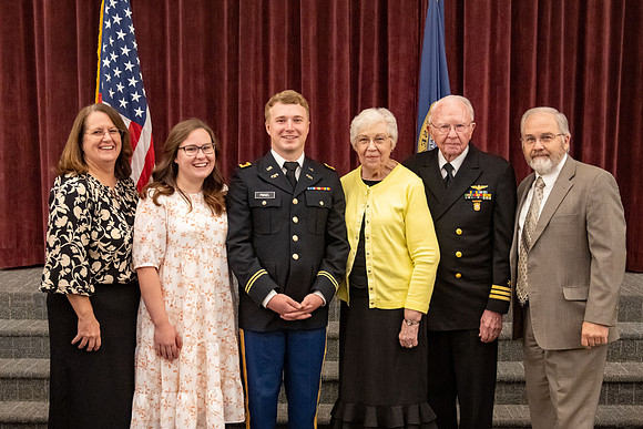 Four graduates from the BYU-Idaho ROTC program gather with the families and have a ceremonial commissioning.