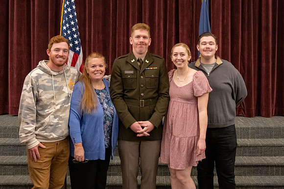 Four graduates from the BYU-Idaho ROTC program gather with the families and have a ceremonial commissioning.