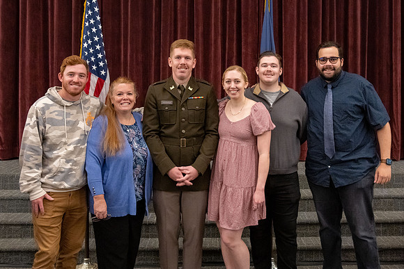 Four graduates from the BYU-Idaho ROTC program gather with the families and have a ceremonial commissioning.