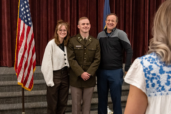 Four graduates from the BYU-Idaho ROTC program gather with the families and have a ceremonial commissioning.