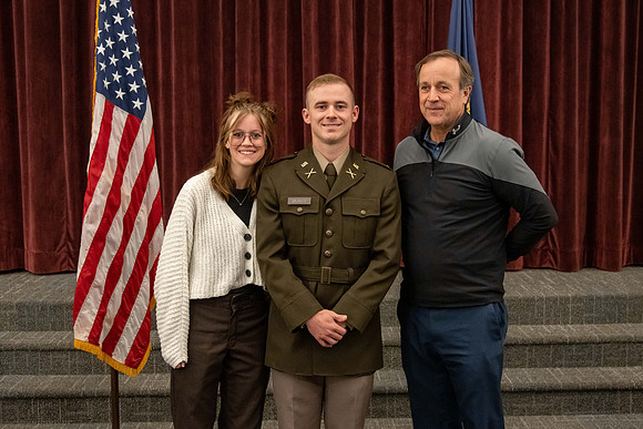 Four graduates from the BYU-Idaho ROTC program gather with the families and have a ceremonial commissioning.