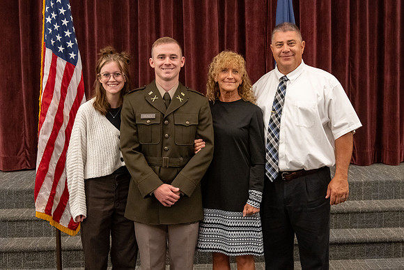 Four graduates from the BYU-Idaho ROTC program gather with the families and have a ceremonial commissioning.