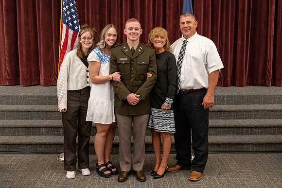 Four graduates from the BYU-Idaho ROTC program gather with the families and have a ceremonial commissioning.