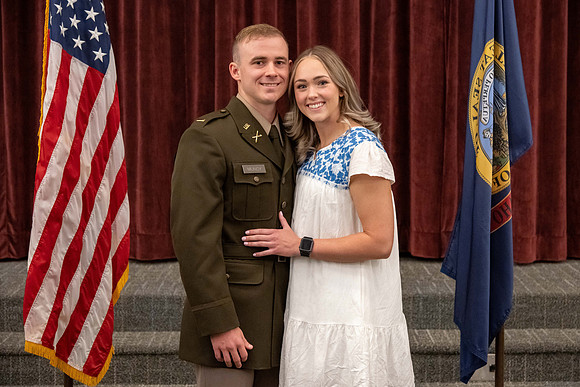 Four graduates from the BYU-Idaho ROTC program gather with the families and have a ceremonial commissioning.