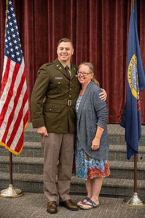 Four graduates from the BYU-Idaho ROTC program gather with the families and have a ceremonial commissioning.