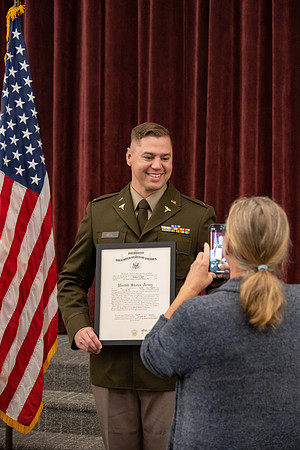 Four graduates from the BYU-Idaho ROTC program gather with the families and have a ceremonial commissioning.