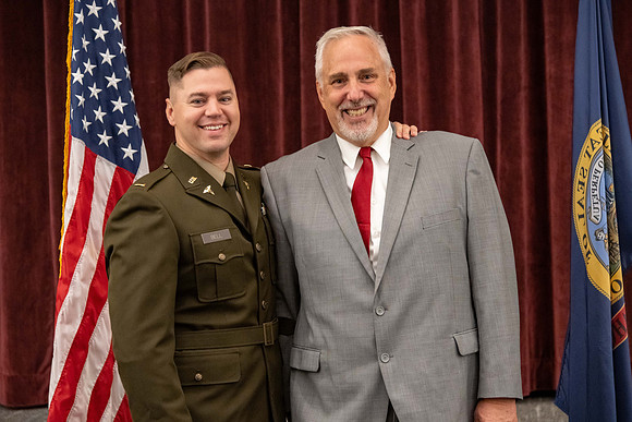 Four graduates from the BYU-Idaho ROTC program gather with the families and have a ceremonial commissioning.