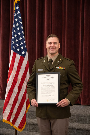 Four graduates from the BYU-Idaho ROTC program gather with the families and have a ceremonial commissioning.