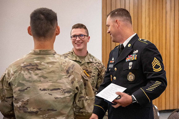 Four graduates from the BYU-Idaho ROTC program gather with the families and have a ceremonial commissioning.